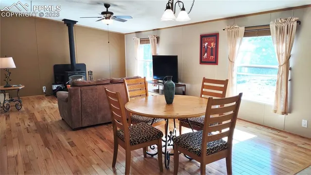 a view of a dining room with furniture window and wooden floor