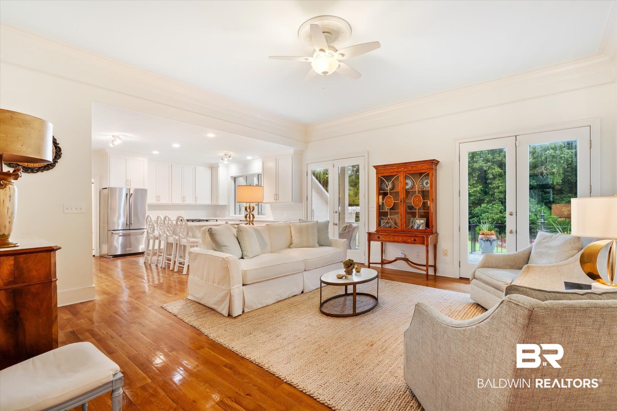 6458 Raintree Road Fairhope, AL 36532 - Photo 11 of 65 Living room with crown molding, french doors, ceiling fan, and light hardwood / wood-style floors