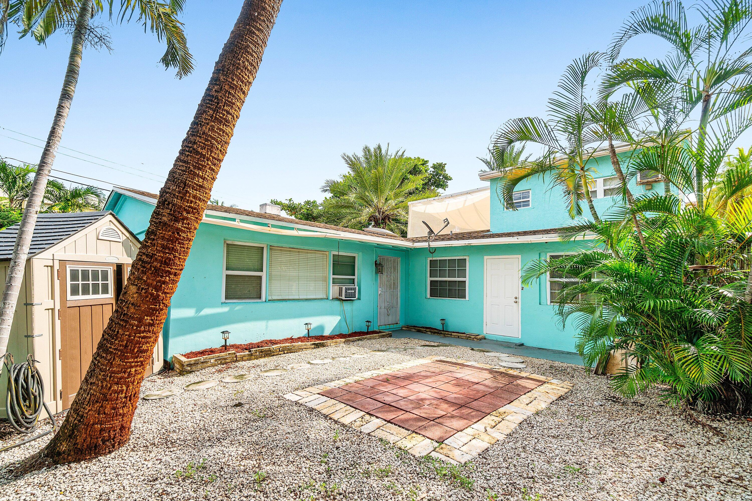 205 Coral Road, Unit 2 Boynton Beach, FL 33435 - Photo 8 of 9 a front view of a house with a garden