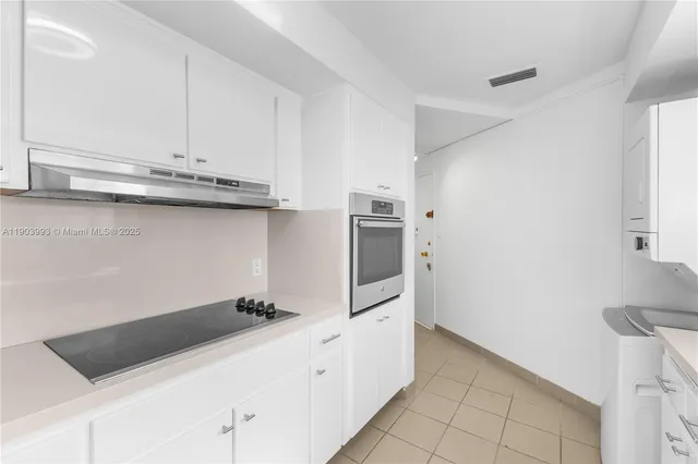 a kitchen with stainless steel appliances a cabinets and a counter top space