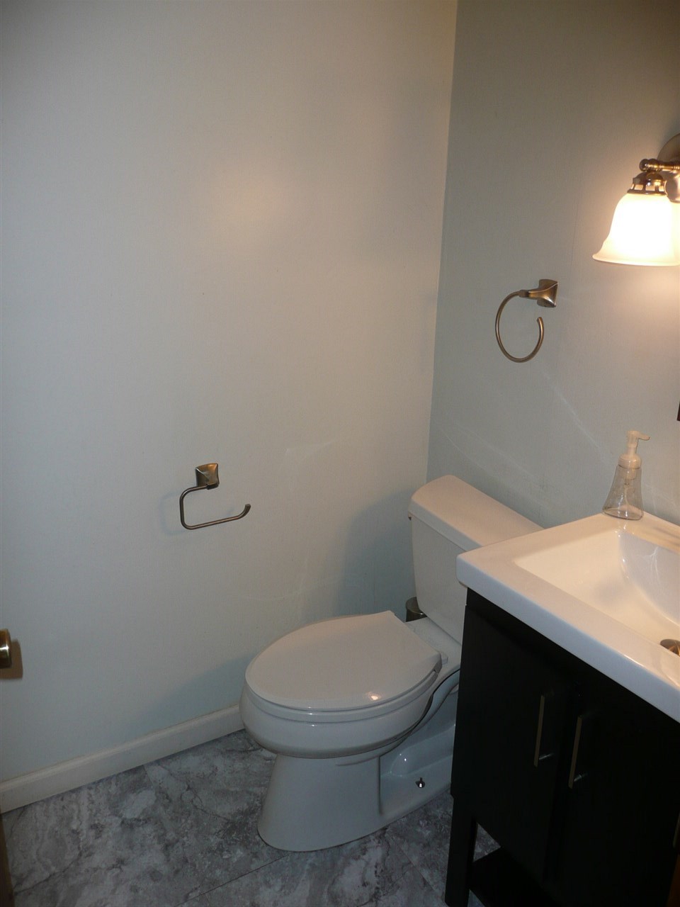 5343 Brookview Road Rockford, IL 61107 - Photo 11 of 22 a white toilet sitting next to a bathroom sink