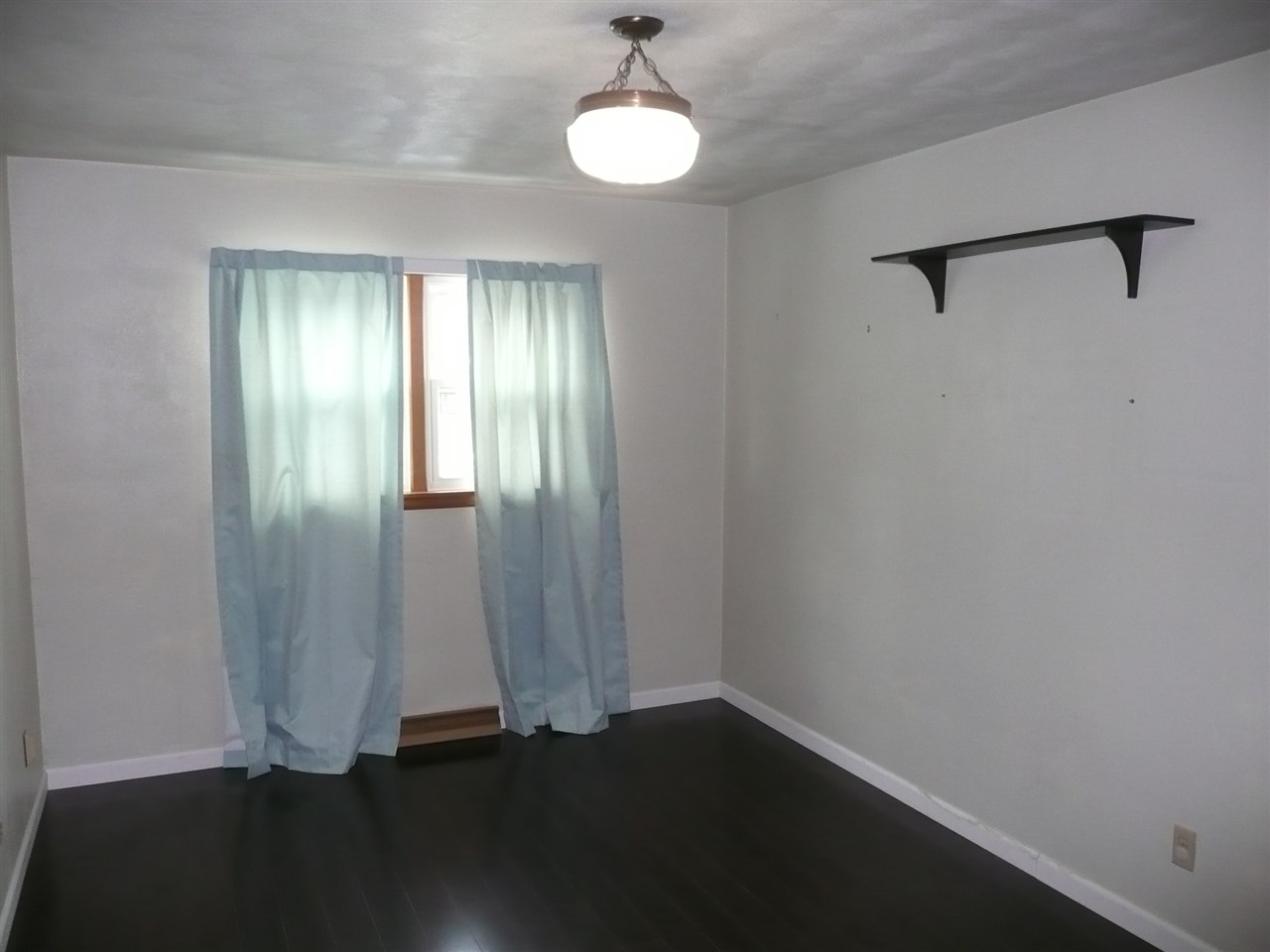 5343 Brookview Road Rockford, IL 61107 - Photo 14 of 22 a view of an empty room with wooden floor and a window