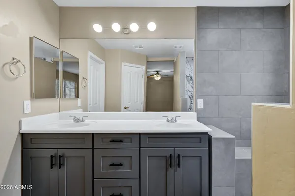 a bathroom with a sink vanity and a mirror