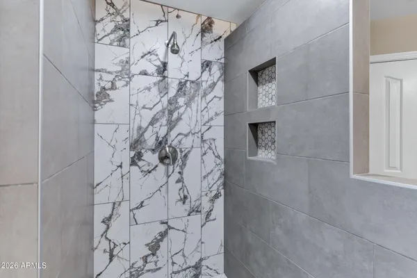 a bathroom with a bathtub and shower