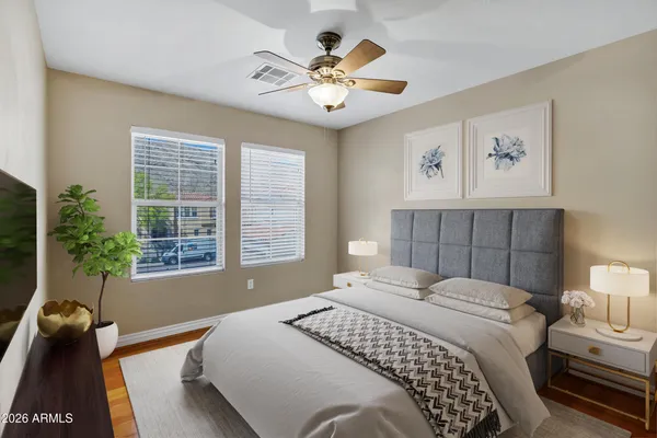 a bedroom with a bed and a large window