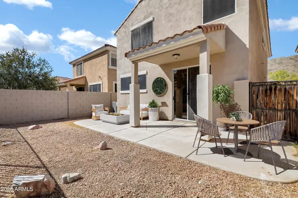 a view of a house with backyard and sitting area