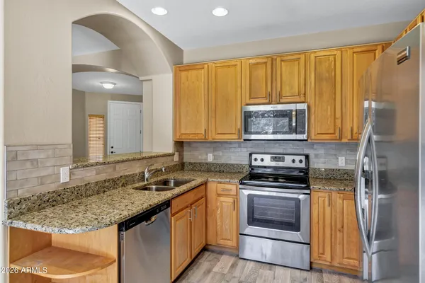 a kitchen with a sink stove and refrigerator