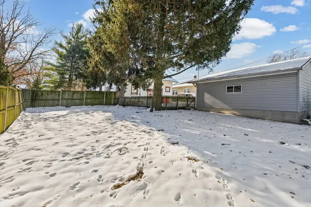 a backyard of a house with large trees