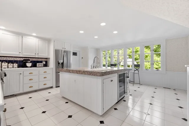 a kitchen with granite countertop a white stove top oven and cabinets