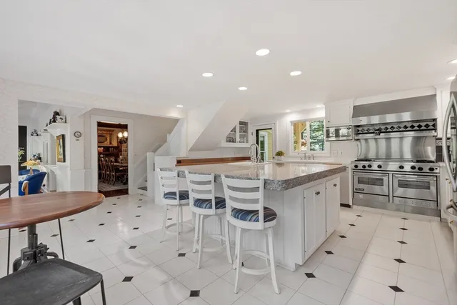 a kitchen with stainless steel appliances kitchen island granite countertop a sink and cabinets