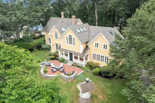 a aerial view of a house with table and chair and grass