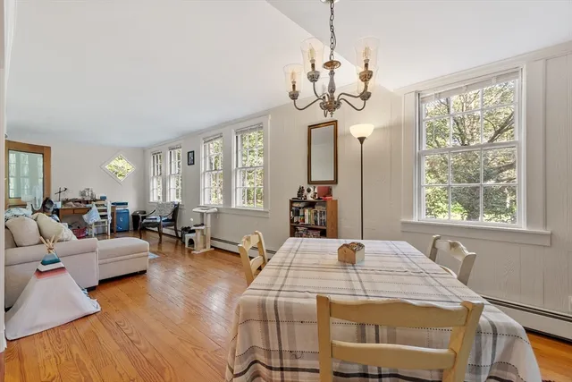 a view of a dining room with furniture wooden floor and chandelier