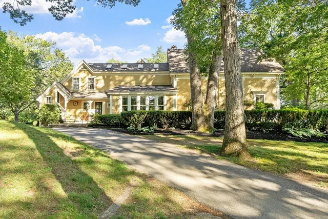 a view of a large trees in front of a house