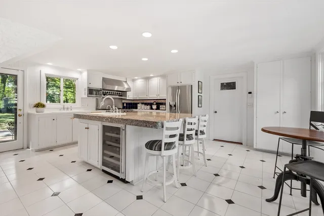 a kitchen with cabinets and chairs in it