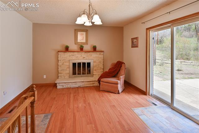 15445 Raton Road Colorado Springs, CO 80921 - Photo 15 of 46 Real wood fireplace attached to kitchen for eat-in area or another sitting space. Walks out to back yard.