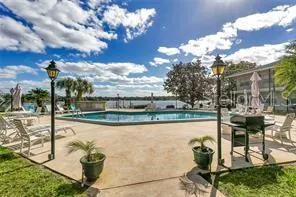 a view of a lake with a table and chairs