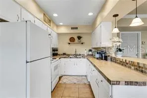 a kitchen with a refrigerator a sink and a refrigerator
