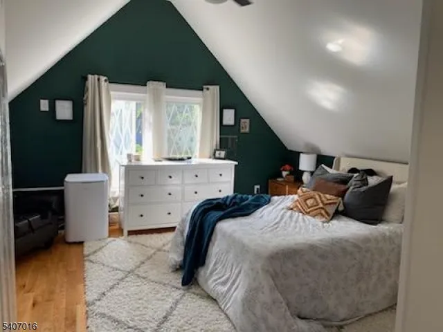 a bedroom with a bed and large windows