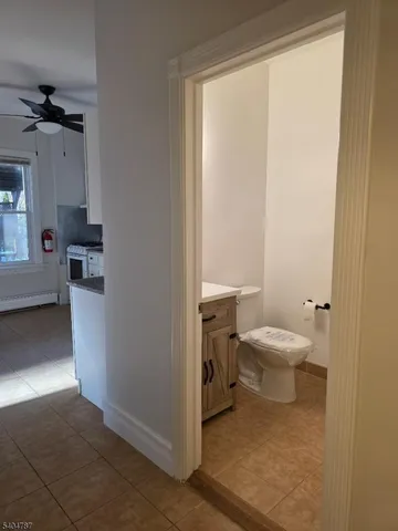 a bathroom with a toilet a sink and a mirror