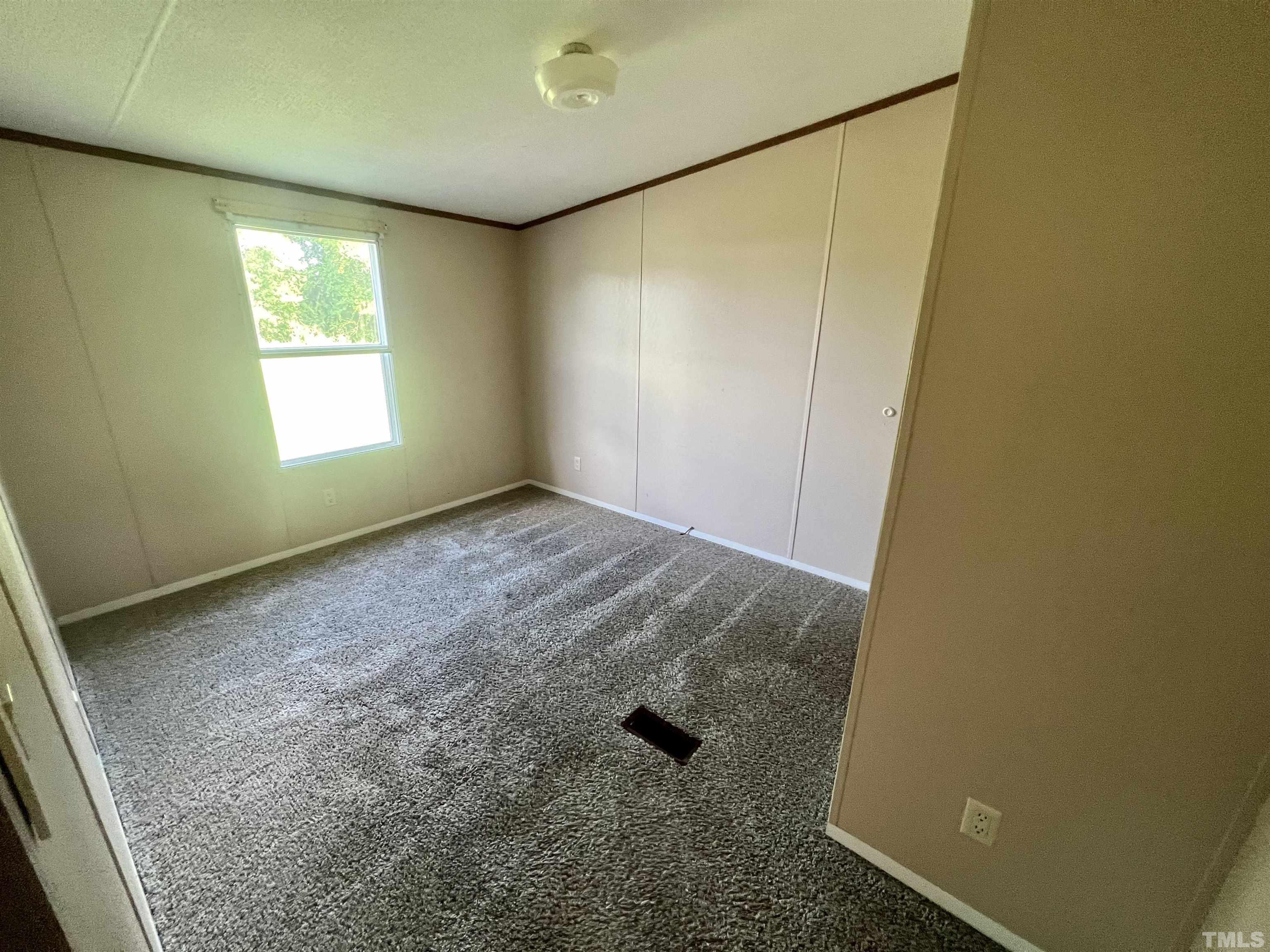 4271 Bryant Pond Road, Unit G Dunn, NC 28334 - Photo 13 of 32 an empty room with windows