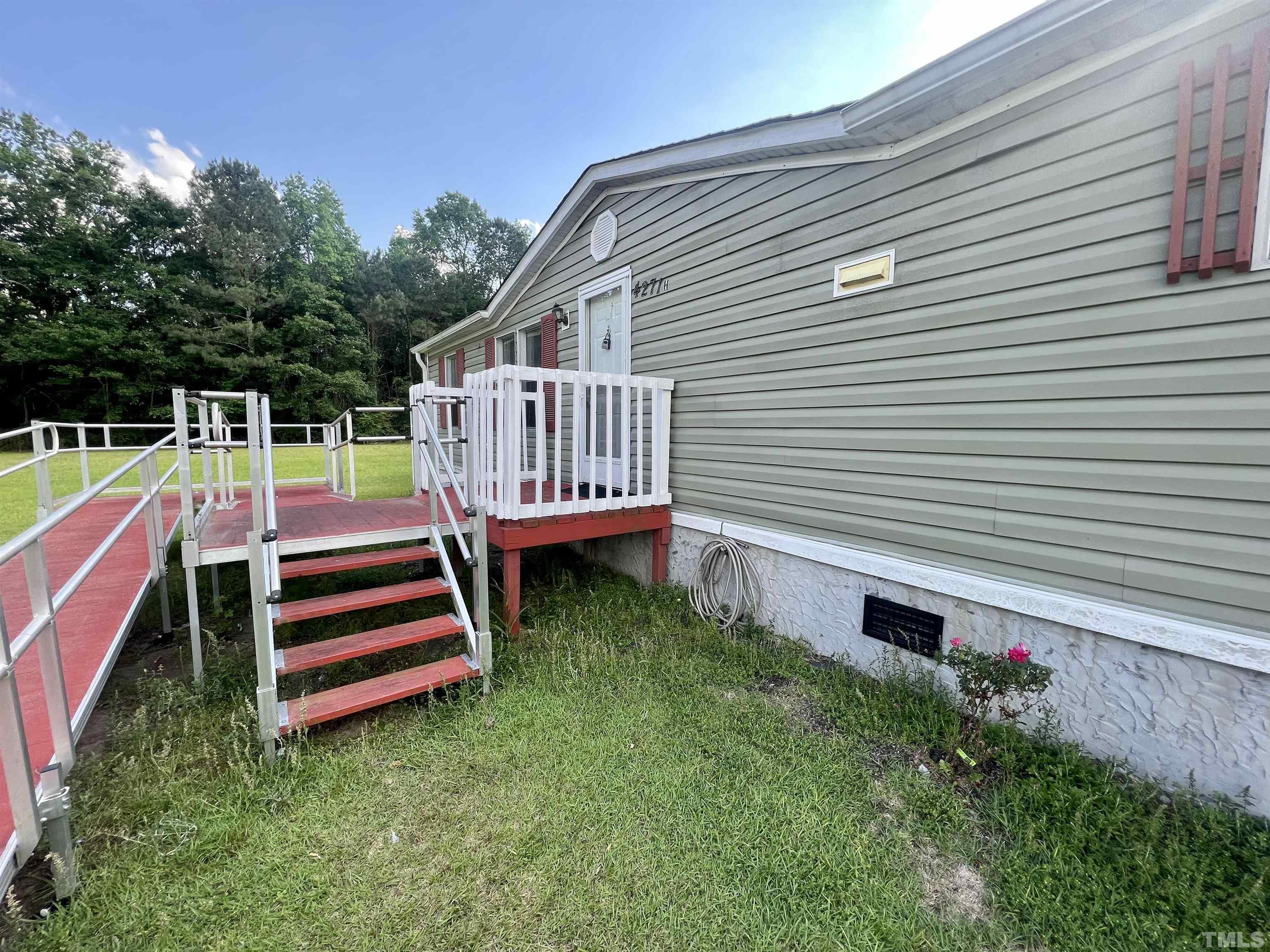 4271 Bryant Pond Road, Unit G Dunn, NC 28334 - Photo 24 of 32 a front view of a house with a yard