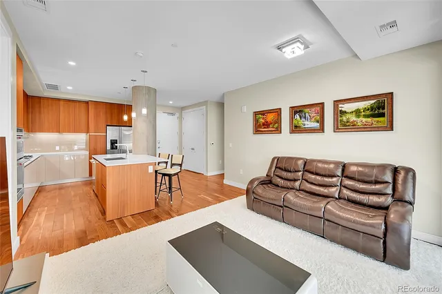 a living room with furniture and kitchen view