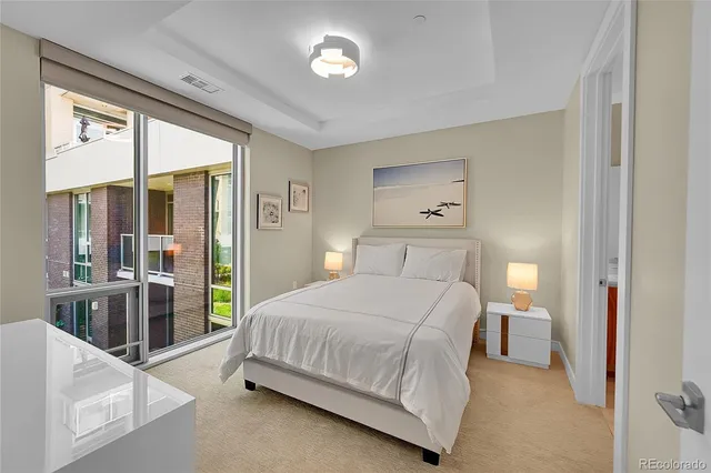 a bedroom with a large bed and a chandelier