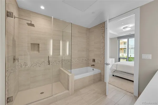 a bathroom with a tub shower and sink