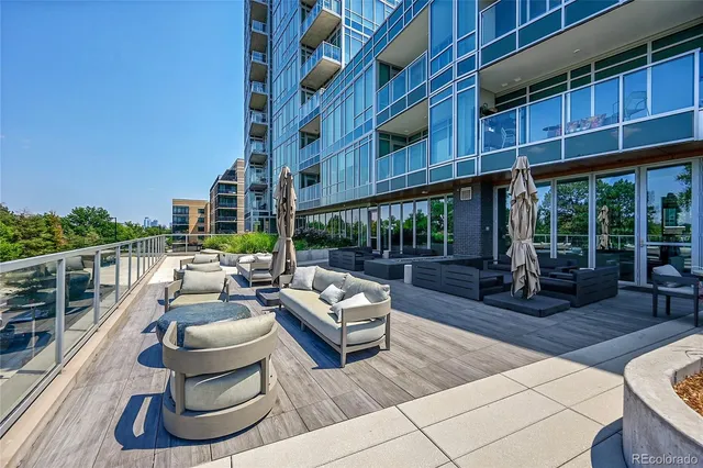 a view of a patio with couches table and chairs and potted plants