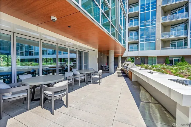 a view of a patio with a table and chairs and potted plants