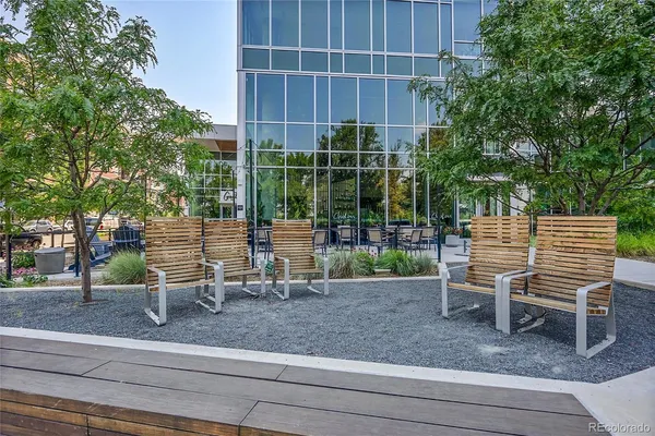 a view of a chairs and bench in the yard