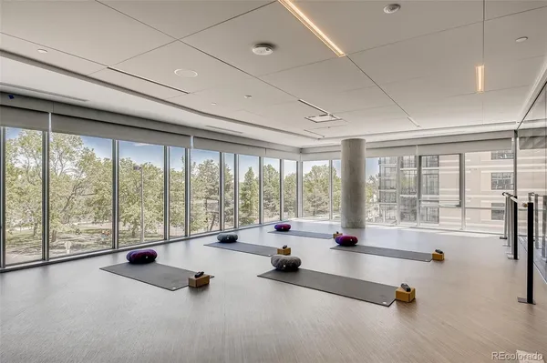 a room with gym equipment and floor to ceiling window