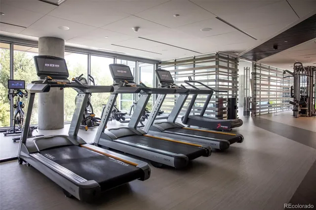 a room with gym equipment and a large window