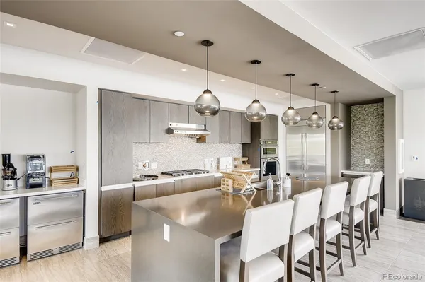 a large kitchen with a table and chairs