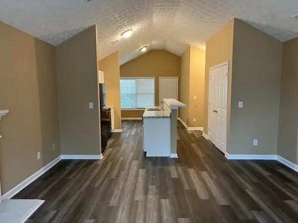 a view of a living room with wooden floor