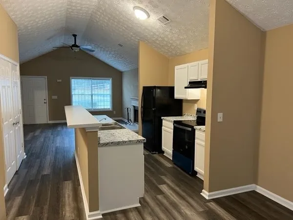 a kitchen with a stove a sink and a refrigerator