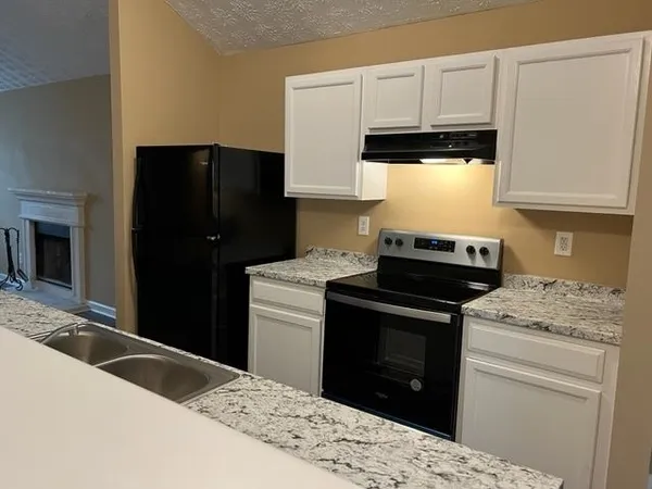 a kitchen with a stove and a refrigerator