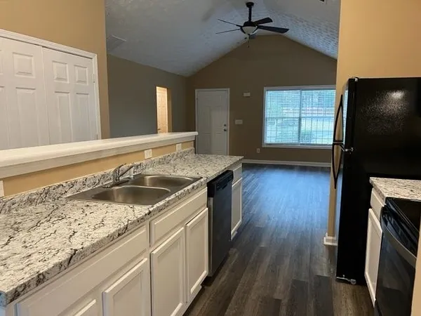 a kitchen with a sink stove and cabinets