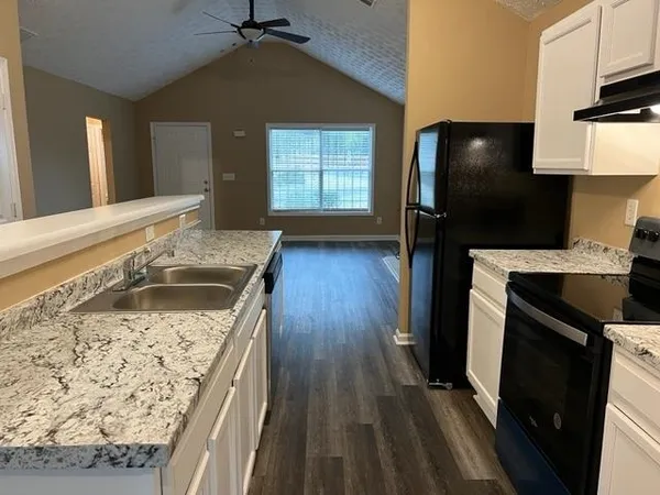 a kitchen with a sink stove and refrigerator