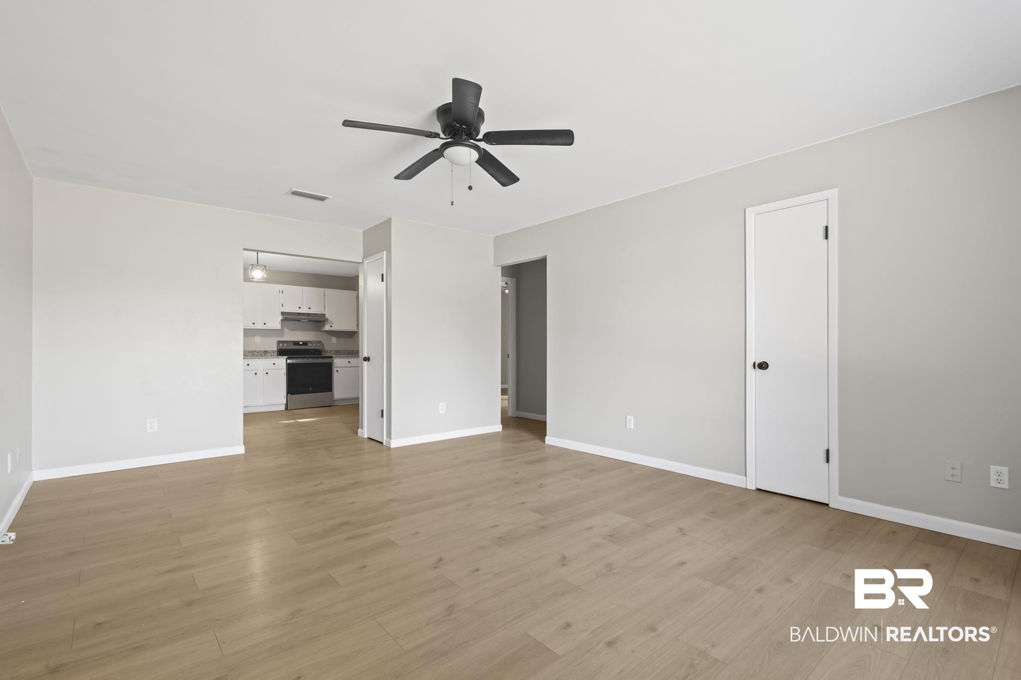 309 West Roosevelt Avenue Foley, AL 36535 - Photo 6 of 60 Unfurnished living room featuring light hardwood / wood-style flooring and ceiling fan