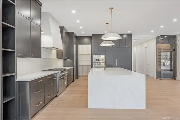 a large kitchen with stainless steel appliances kitchen island a large island in the center
