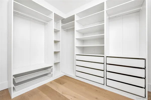 a view of walk in closet with empty racks
