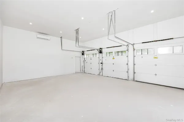 an empty room with windows and stairs