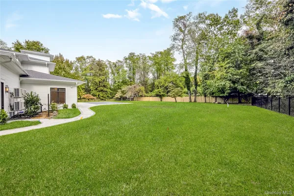 a view of house with a backyard