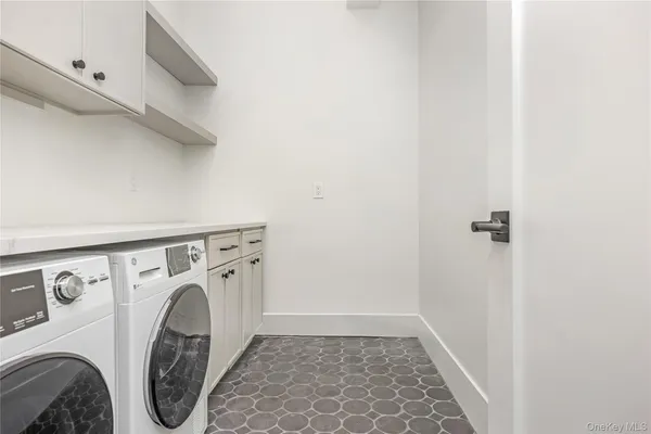 a utility room with sink dryer and washer