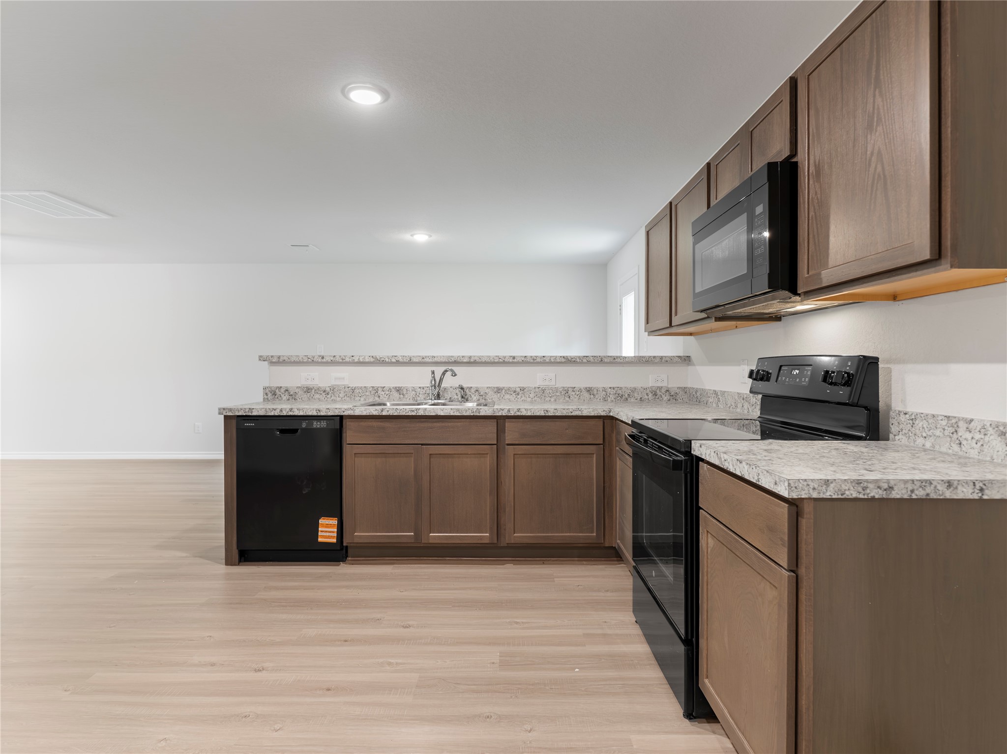 306 North Orange Street Sweeny, TX 77480 - Photo 10 of 30 Stunning kitchen featuring sleek black appliances for a modern touch.