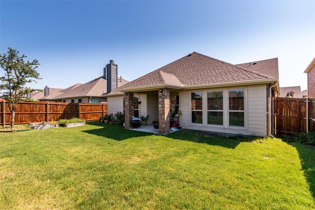 504 Rocky Pine Road McKinney, TX 75072 - Photo 33 of 36 Back of house featuring a fenced backyard and a shingled roof