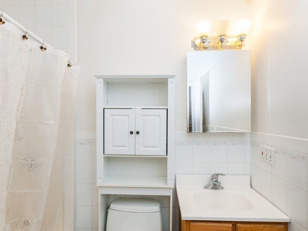 12 Regent Street Cambridge, MA 02140 - Photo 15 of 18 a bathroom with a sink and a mirror
