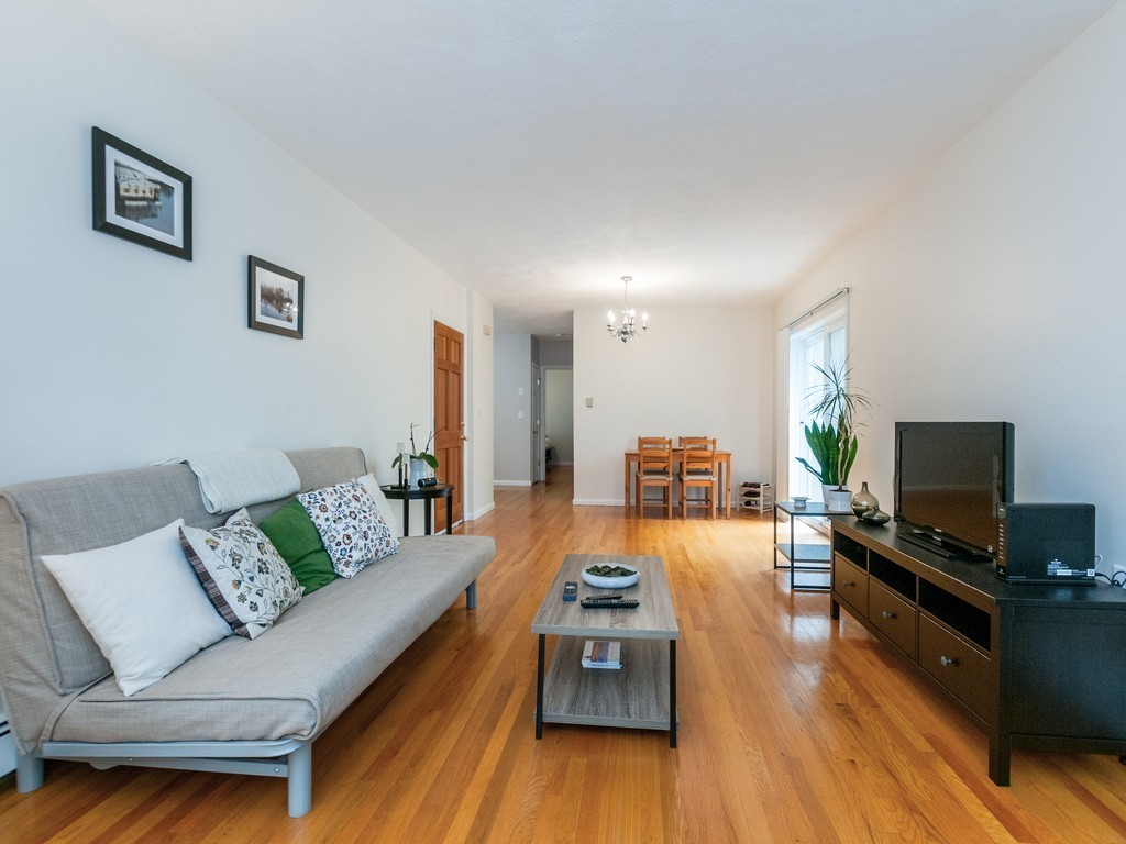 12 Regent Street Cambridge, MA 02140 - Photo 2 of 18 a living room with furniture and a flat screen tv