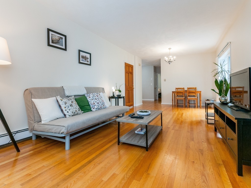 12 Regent Street Cambridge, MA 02140 - Photo 3 of 18 a living room with furniture and a flat screen tv